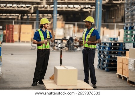 Operational staff push products to the dispatch area while handling work instructions. Worker in warehouse and delivery industry.