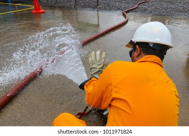 An Operator Is Controlling Pressurised Water From A Portable Fire Monitor.