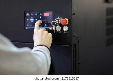 Operator controls modern equipment using a touch control panel. Selective focus.