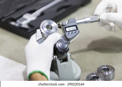operator inspection high precision automotive part by micrometer
