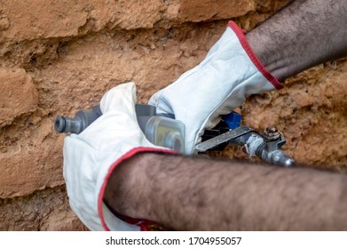 Operator Installing A Water Pressure Regulator On A Tap, Spain, Andalusia