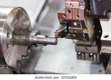 Operator machining automotive part by cnc turning machine