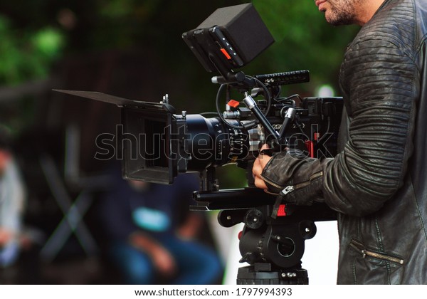 operator make the film movie on a professional\
cinema camera\
production