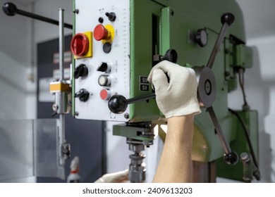The operator operates a mechanically controlled drilling machine.