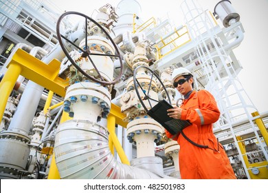 operator recording operation of oil and gas process at oil and rig plant, offshore oil and gas industry, offshore oil and rig in the sea, operator monitor production process, routine daily record.