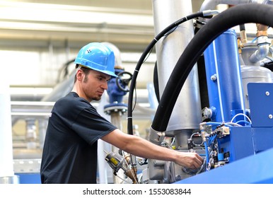 Operator Repairs A Machine In An Industrial Plant With Tools - Pneumatics And Hydraulics