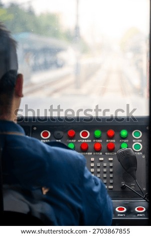 Operator's View Inside a Train Cab with Control Panel and Railway Tracks Ahead