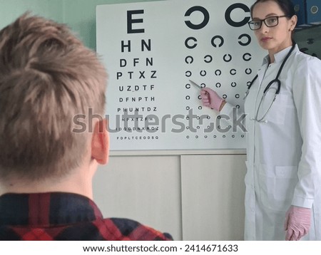 Ophthalmologist checking eyesight of teenage boy. Farsightedness and myopia diagnostics