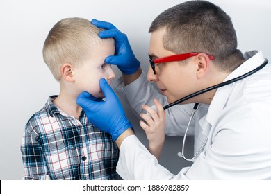 An Ophthalmologist Examines A Boy Who Complains Of Burning And Pain In His Eyes. Eye Fatigue From A Computer Or Phone Screen (sensation Of Sand On The Cornea). Diagnosis Of Conjunctivitis In Children.