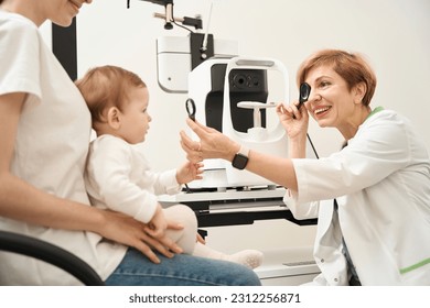 Ophthalmologist performing vision screening in child at initial consultation - Powered by Shutterstock