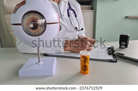 Ophthalmologist writes a prescription for pill for eyes. Eye vitamins and retinoprotectors