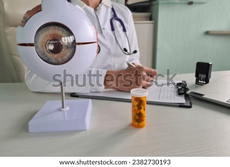 Ophthalmologist writes prescription for pill for eyes. Eye vitamins and radioprotectors
