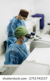 Ophthalmologists specializing in vision correction using advanced medical equipment in a modern operating room
