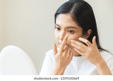 Ophthalmology care, eye sight, vision concept. Asian young woman, female hand holding and putting, wearing soft contact lenses with finger on face, girl looking in mirror at home. Medicine and health. - Powered by Shutterstock