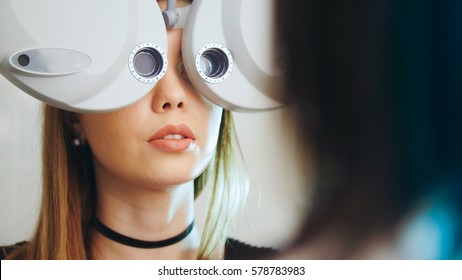 Ophthalmology clinic - woman checks vision by modern equipment - eyes exam