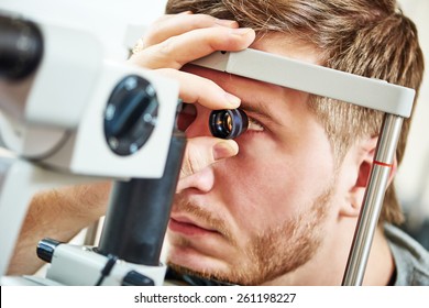Ophthalmology concept. Male patient under eye vision examination in eyesight ophthalmological correction clinic 