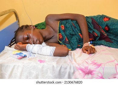 Opialu, Benue State - March 6, 2021: African Parent Caring For Sick Child In A Rural Clinic