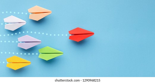 Opinion Leadership Concept. Red Paper Plane Leading Another Colorful Ones, Influencing The Crowd, Blue Background, Panorama