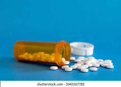 Opioid Crisis - Open Bottle of Prescription Painkillers. Medicare, overdose.