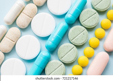 Opioid painkillers crisis and drug abuse concept. Opioid and prescription medication addiction epidemic. Different kinds of multicolored pills. Pharmaceutical medicament background