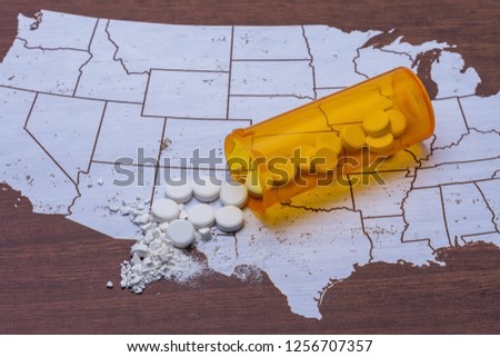 Opioid and prescription drug epidemic concept in United States with pills and bottle and room for copy text