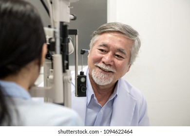 Opitcian With Patient. Senior Chinese Optician With His Asian Woman Patient In Optician Room Examine Her Eye. Real Optician Room In Hospital. Medical Concept.