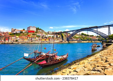 Oporto or Porto city skyline, Douro river, traditional boats and Dom Luis or Luiz iron bridge. Portugal, Europe.