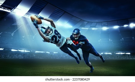 Opponents. Two active american football players in motions, playing, catching ball isolated at the stadium with flashlights. Concept of sport, challenges, goals, strength, competition, team. - Powered by Shutterstock