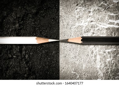 Opposite direction. The concept of confrontation and opposition. Black and white pencils on the surface with opposite colors. - Shutterstock ID 1640407177
