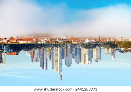 opposite. a village becomes a city. village and city reflected in the water . Urban and non urban Reflections. 