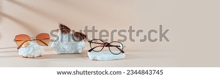 Optic store advertisement banner. Tortoiseshell frame Eyeglasses, glamour sunglasses with plastic Frame and trendy sunglasses in metallic frame on beige Background. Copy space. Optic store web line