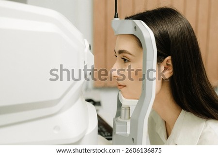 Optical coherence tomography OCT scan to create pictures of the back of eye. Examination of eyes of patient using optical coherence tomograph. Ophthalmologist is scanning cornea of girl patient