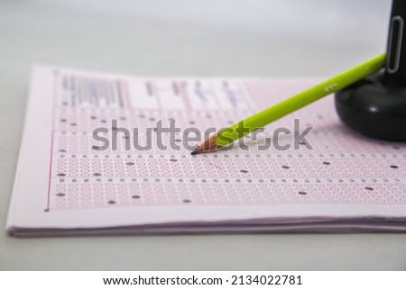 Optical exam answer sheet with pencil.