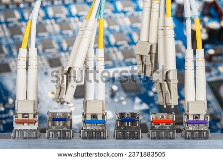 Optical fibre patch cords and gbic connected to the switch with Print Circuit Board in Background