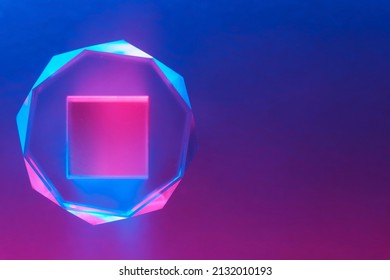 Optical glass objects with multi-colored lighting. Neon background with geometric shapes, soft selective focus, copy space.