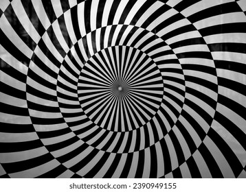 Optical illusion spiral with black and white stripes.