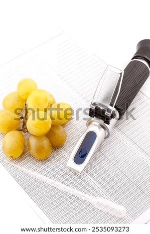 Optical refractometer for measuring grape sugar in the production of wine and spirits. Selective focus with shallow depth of field.