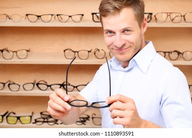 Optical Salon. The Man Chooses Spectacle Frames In The Optical Salon