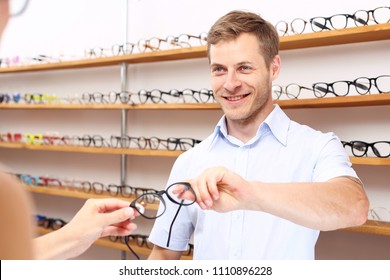 Optical Salon. The Man Chooses Spectacle Frames In The Optical Salon