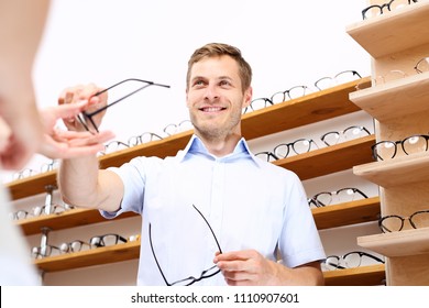 Optical Salon. The Man Chooses Spectacle Frames In The Optical Salon