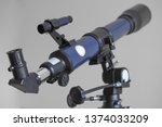 Optical telescope, close up viewfinder of refracting device instrument for land lunar or planetary observation of distant object, magnified by lenses. Long blue focal tube, black eyepiece. Astronomy.