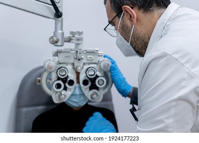 Optician Measuring A Woman's Eyesight