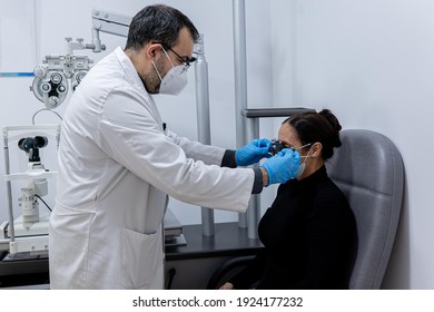 Optician Measuring A Woman's Eyesight