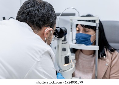 Optician Measuring A Woman's Eyesight