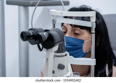 Optician Measuring A Woman's Eyesight