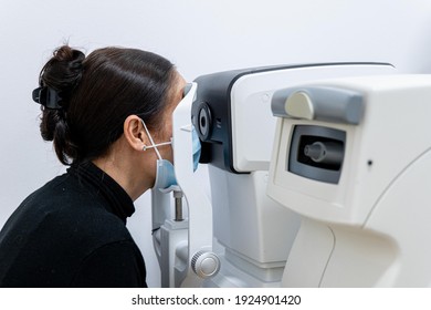 Optician Measuring A Woman's Eyesight