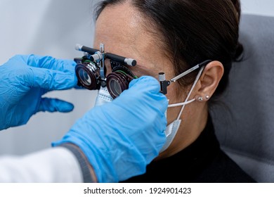 Optician Measuring A Woman's Eyesight