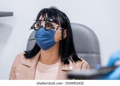 Optician Measuring A Woman's Eyesight