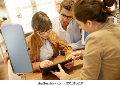 Optician Showing Lenses On Tablet Screen