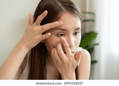 Optimise vision by contact lens, Close-up of woman face during insert contact lens to her eyes. - Powered by Shutterstock